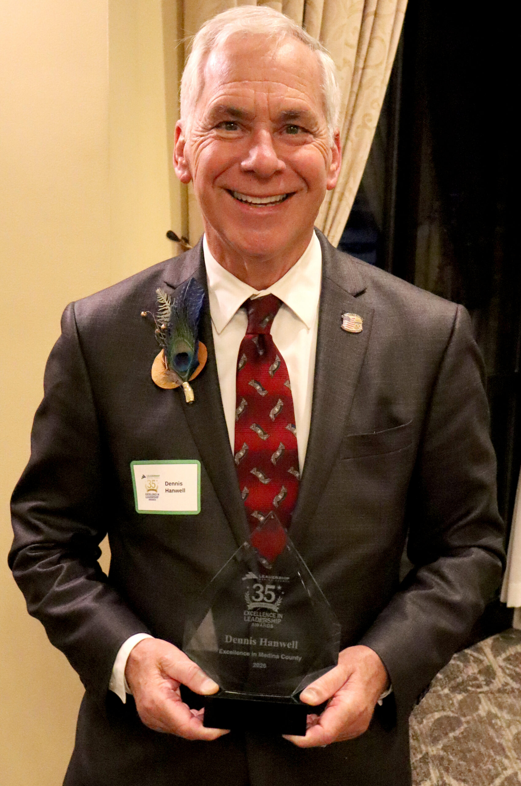 Mayor Dennis Hanwell holding award